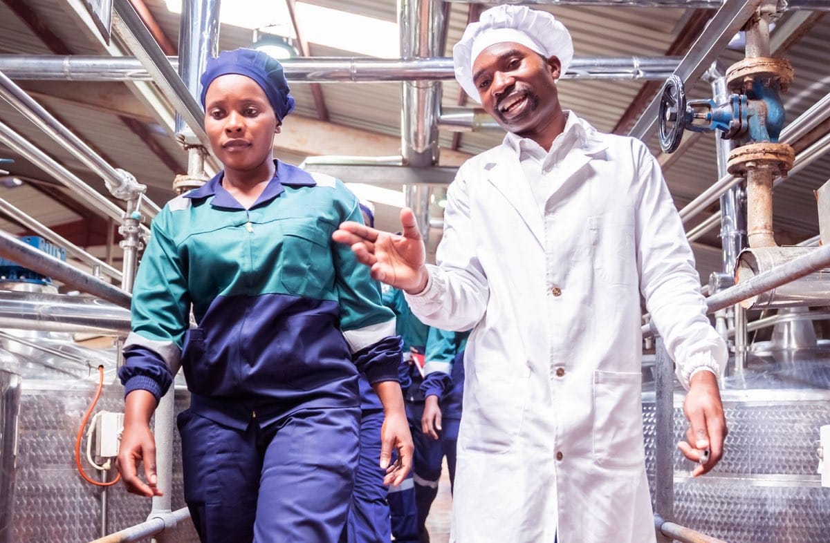 Factory Worker Walking with Her Supervisor at a Factory